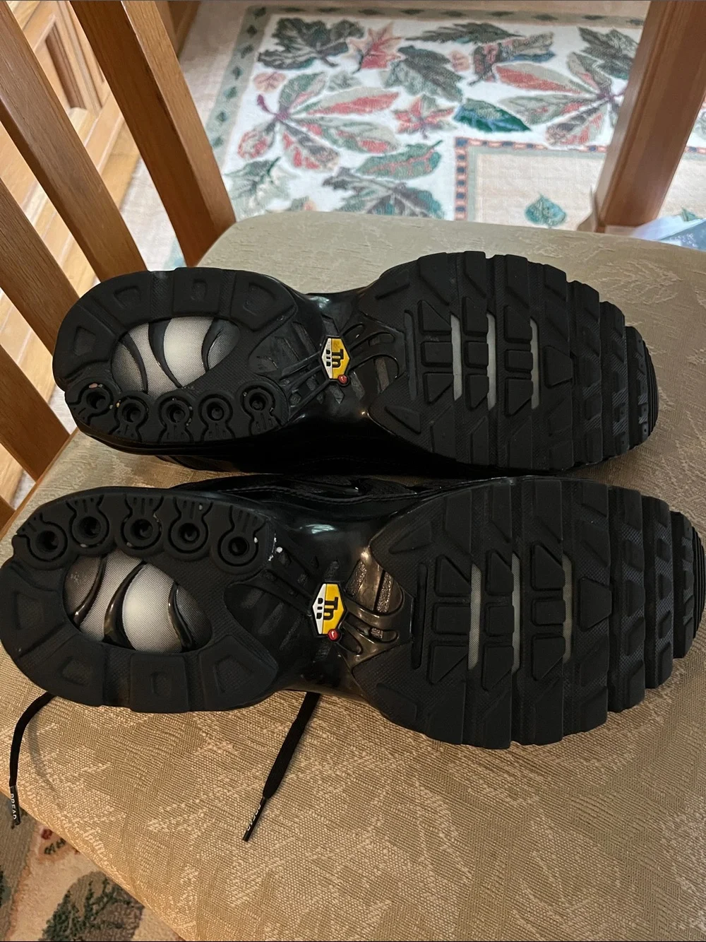 Nike Air Max Plus (Men’s) Triple Black Sneakers with Subtle Red Interior Accents
